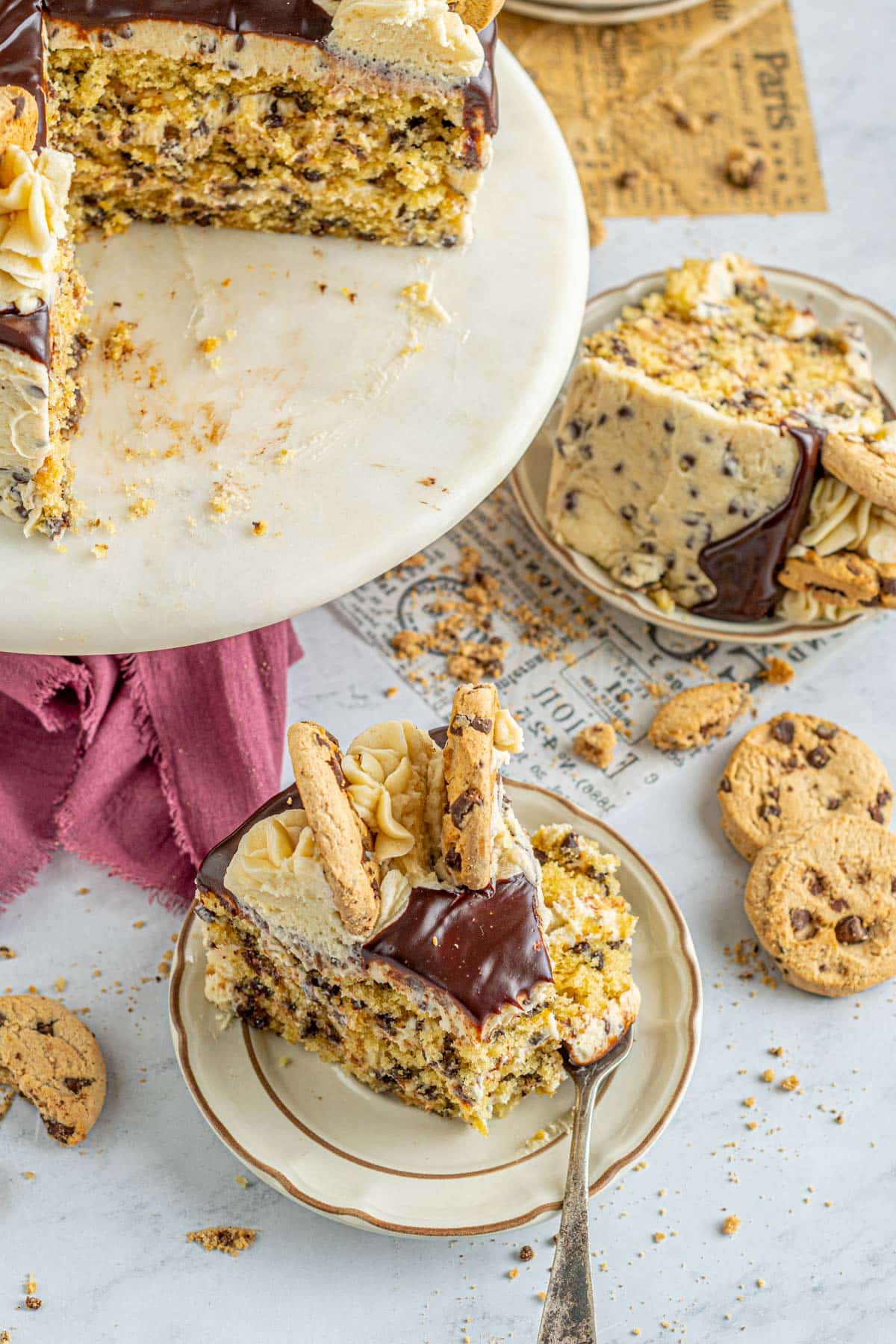 pieces of cake on plates surrounded by cookies