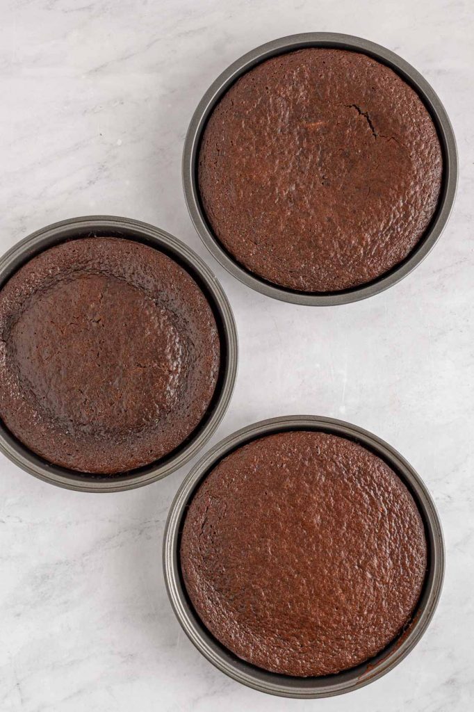 three cake pans with baked cake inside