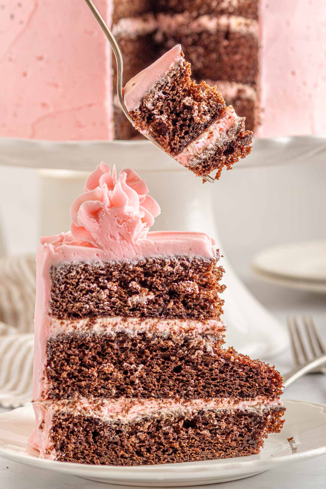 fork with a big velvety bite of strawberry chocolate kahlua cake