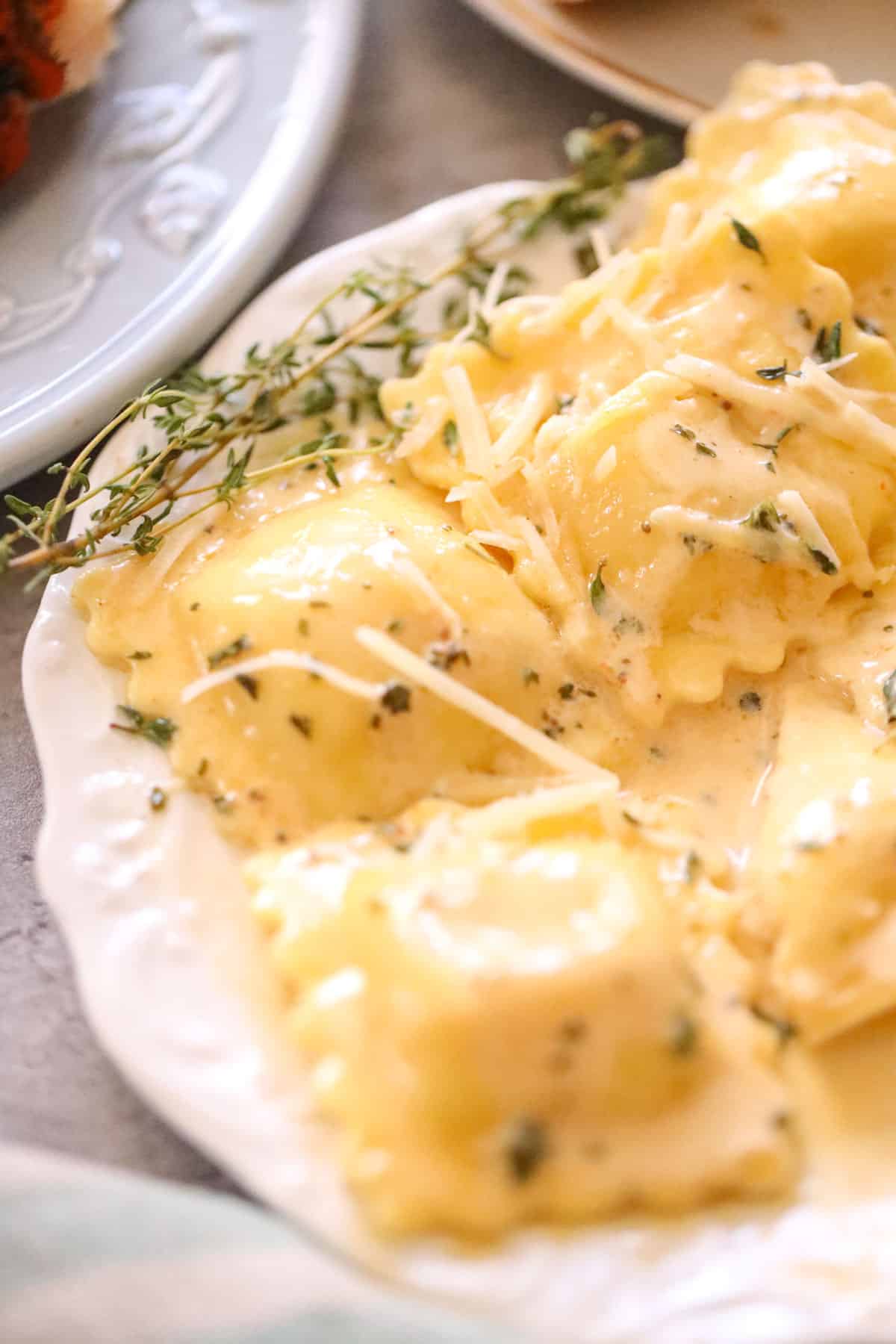 ravioli smothered in creamy sauce with parsley