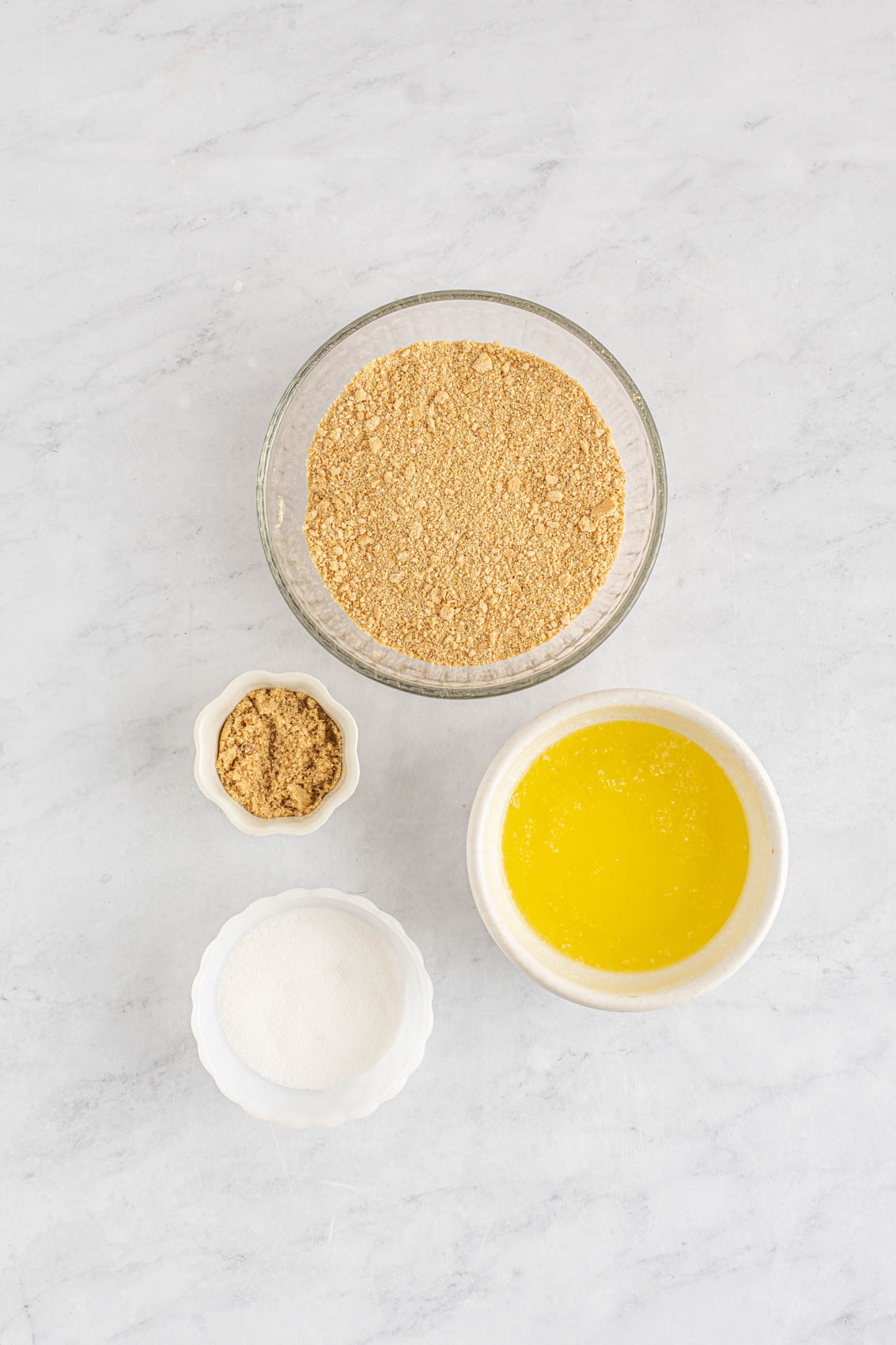 cheesecake crust ingredients, including butter, crumbs and cream cheese