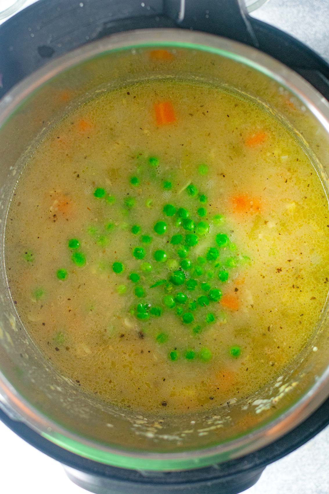adding peas and carrots