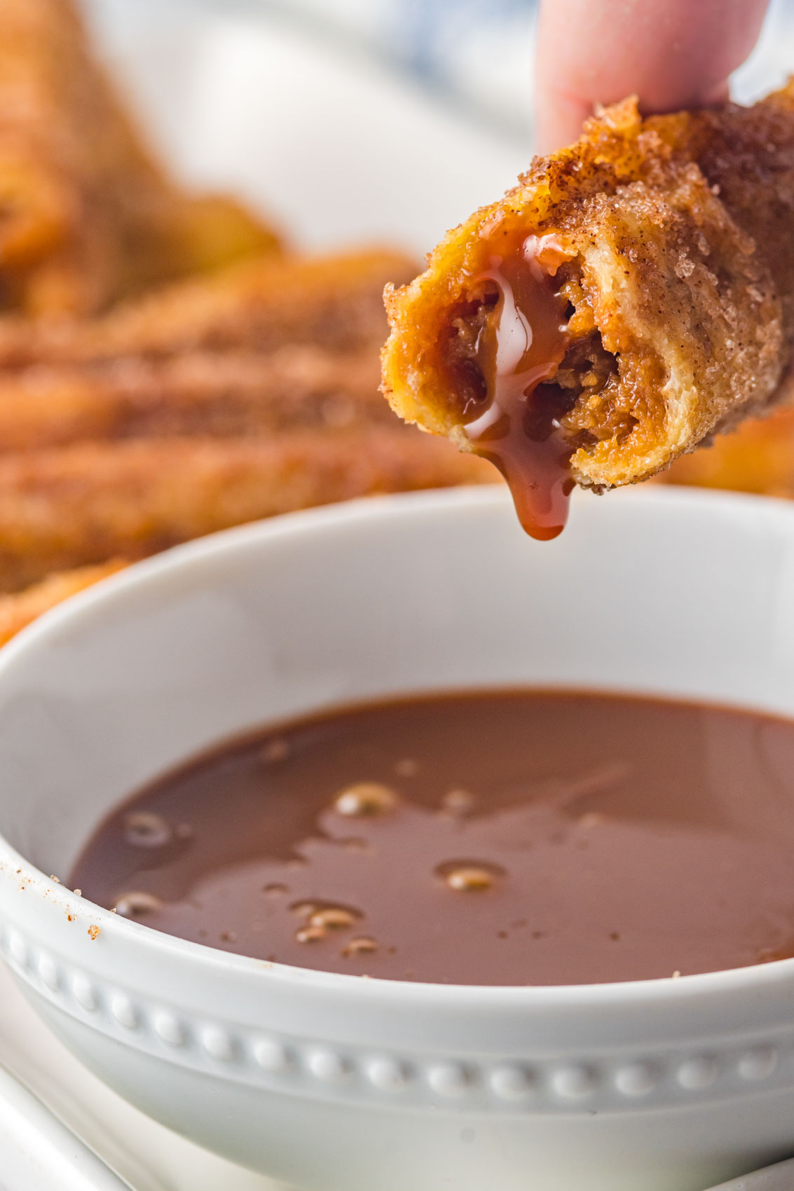 churros french toast roll ups dipped into dulce de leche