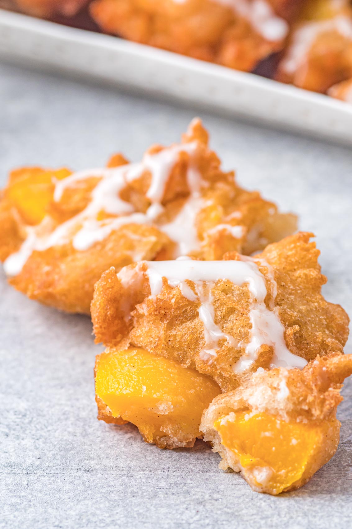 peach fritter with drizzle all over