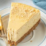 nutter butter peanut butter cheesecake with a fork and bite