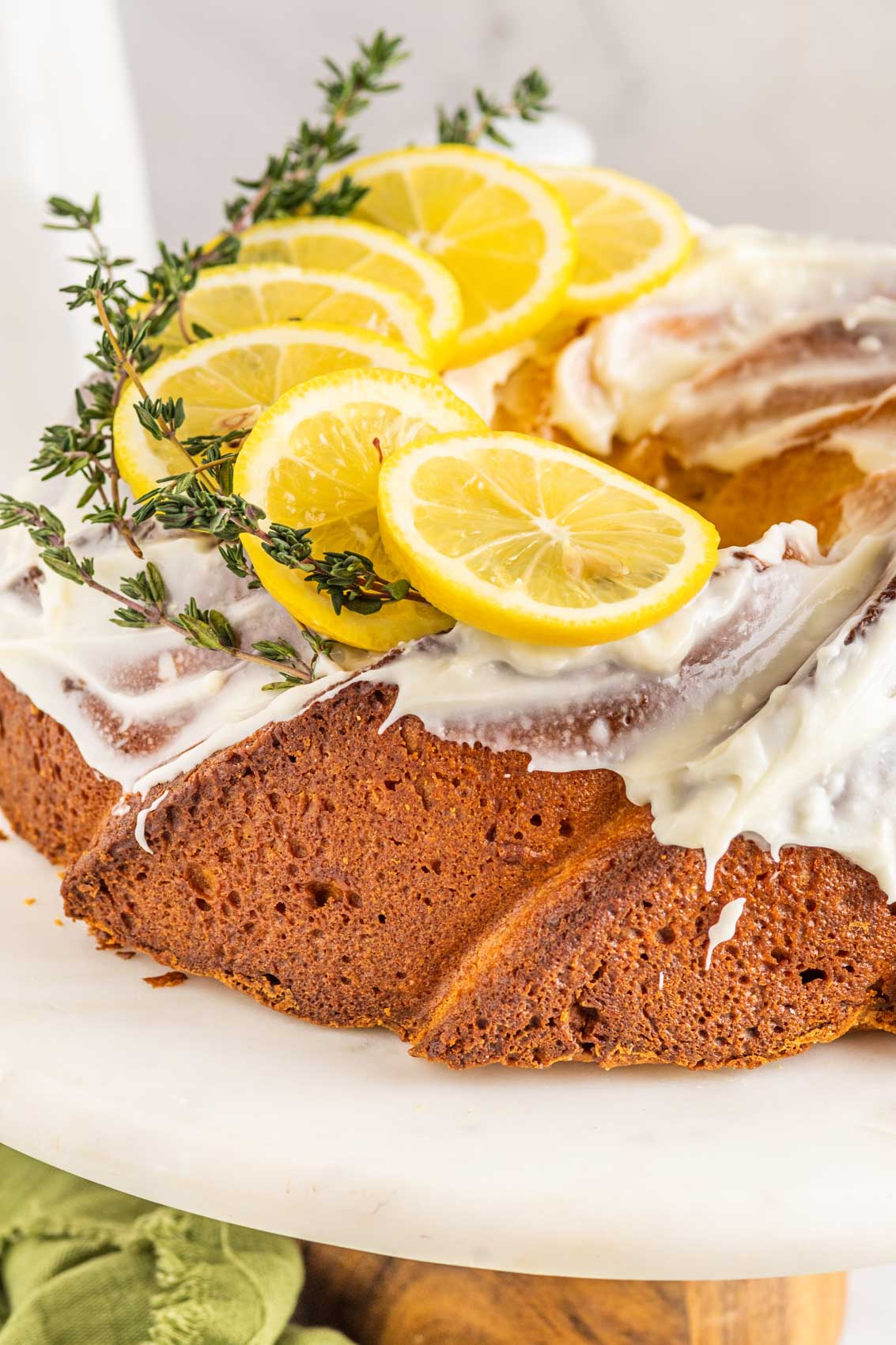 lemon pound bundt cake with fresh vibrant yellow slices of lemon on top