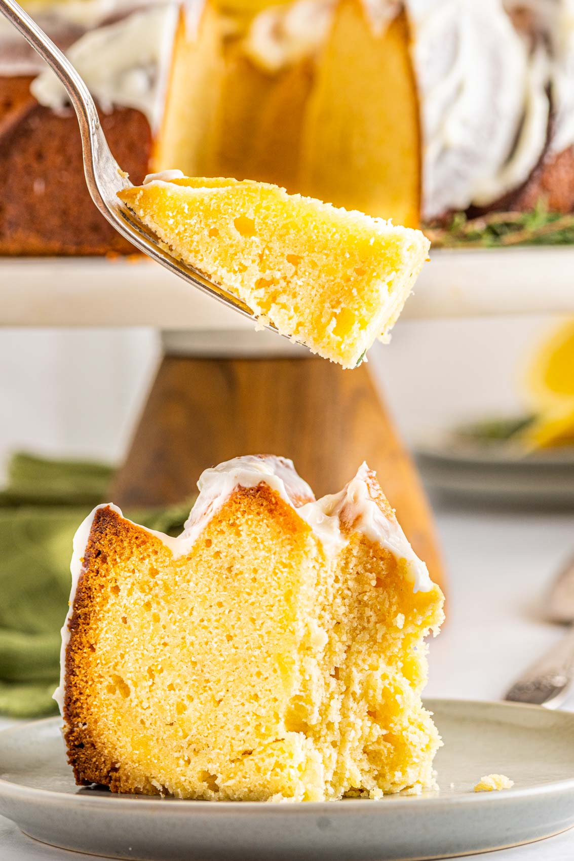 bite of lemon pound cake on a fork, revealing moist inside