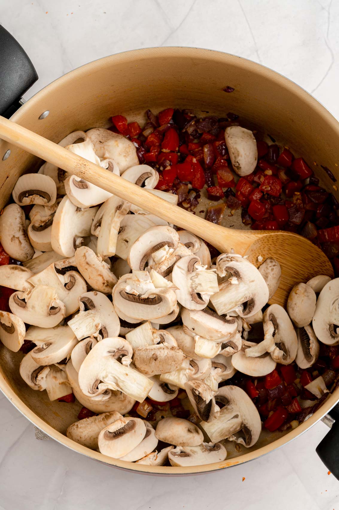 adding mushrooms to pan