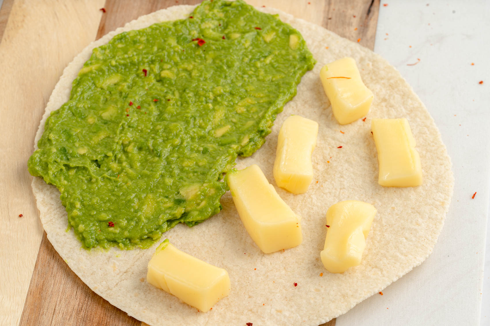 tortilla with cheese and mashed avocado