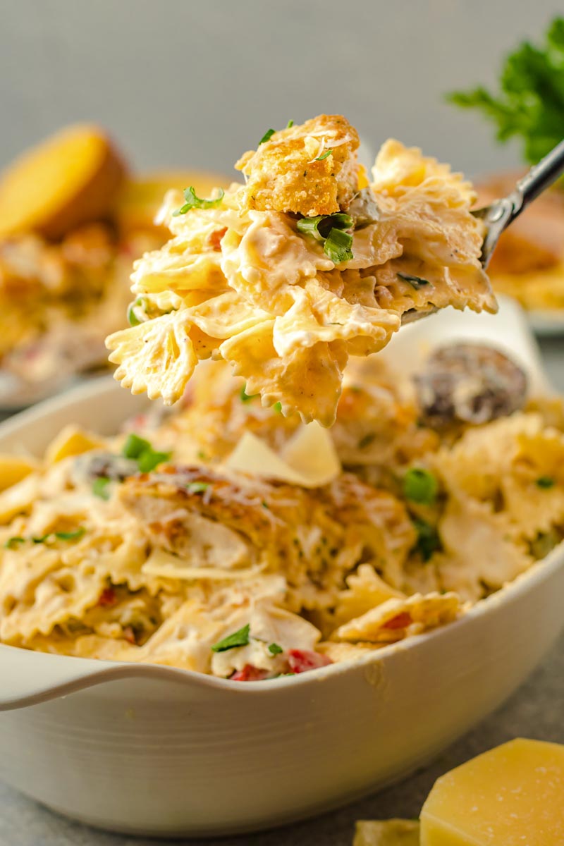 crisp parmesan chicken with creamy cajun sauce on a bed of bowtie pasta