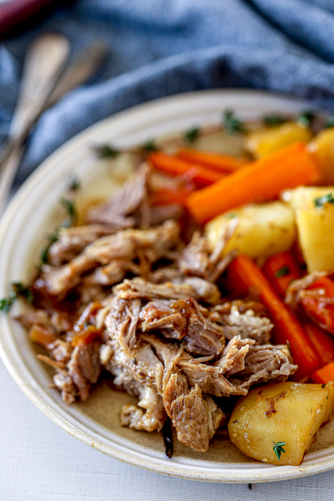 plate with potatoes, carrots and pork roast with savory onion glaze