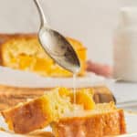 glaze being poured from a spoon onto sweet peach bread