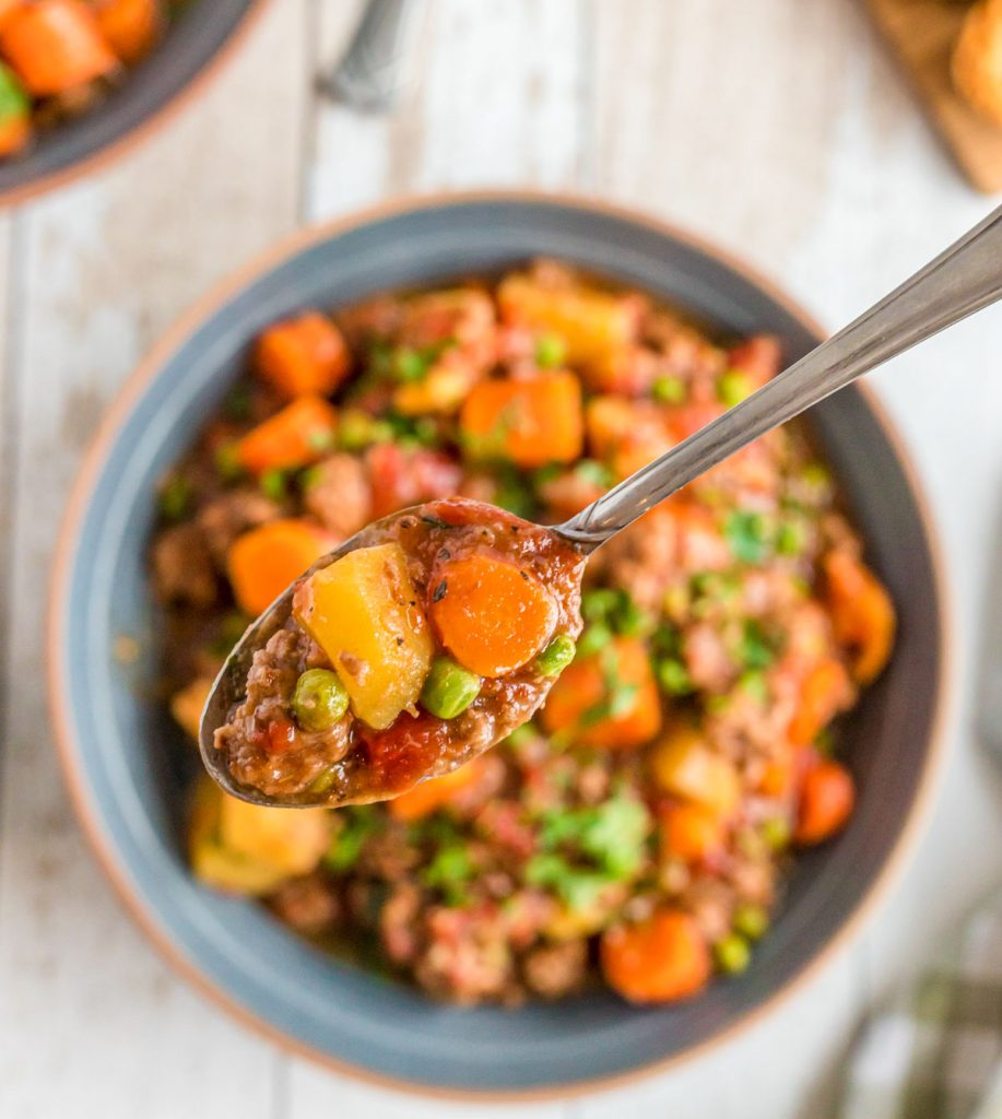 spoonful of thick hamburger meat stew with carrots and potaotes