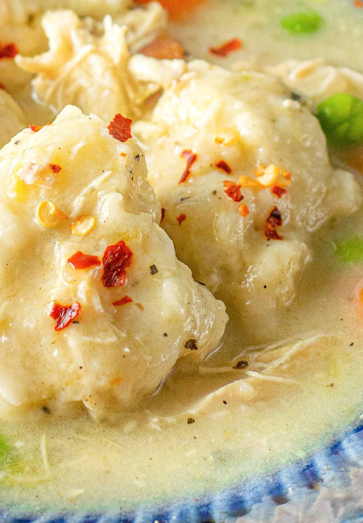 thick, velvety dumplings in a bowl with red pepper flakes