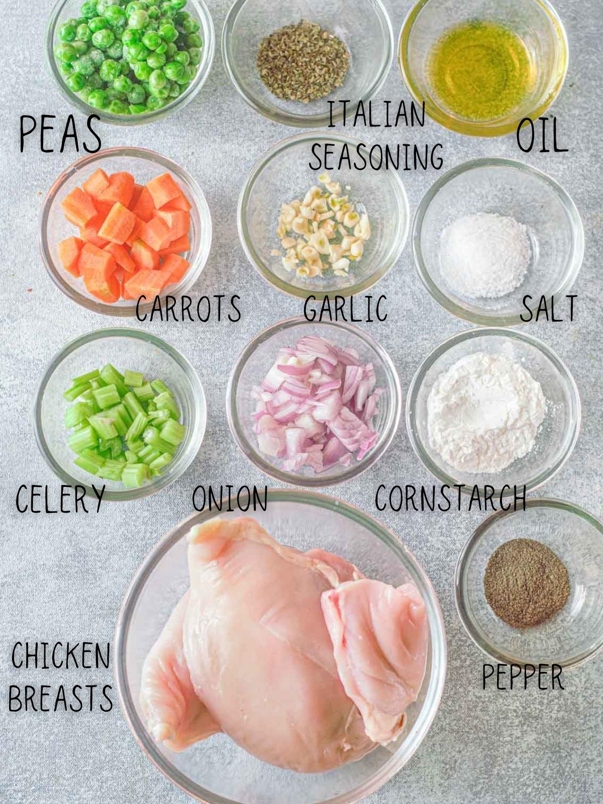ingredients for instant pot chicken and dumplings, including peas, carrots, potatoes, garlic, onion and celery