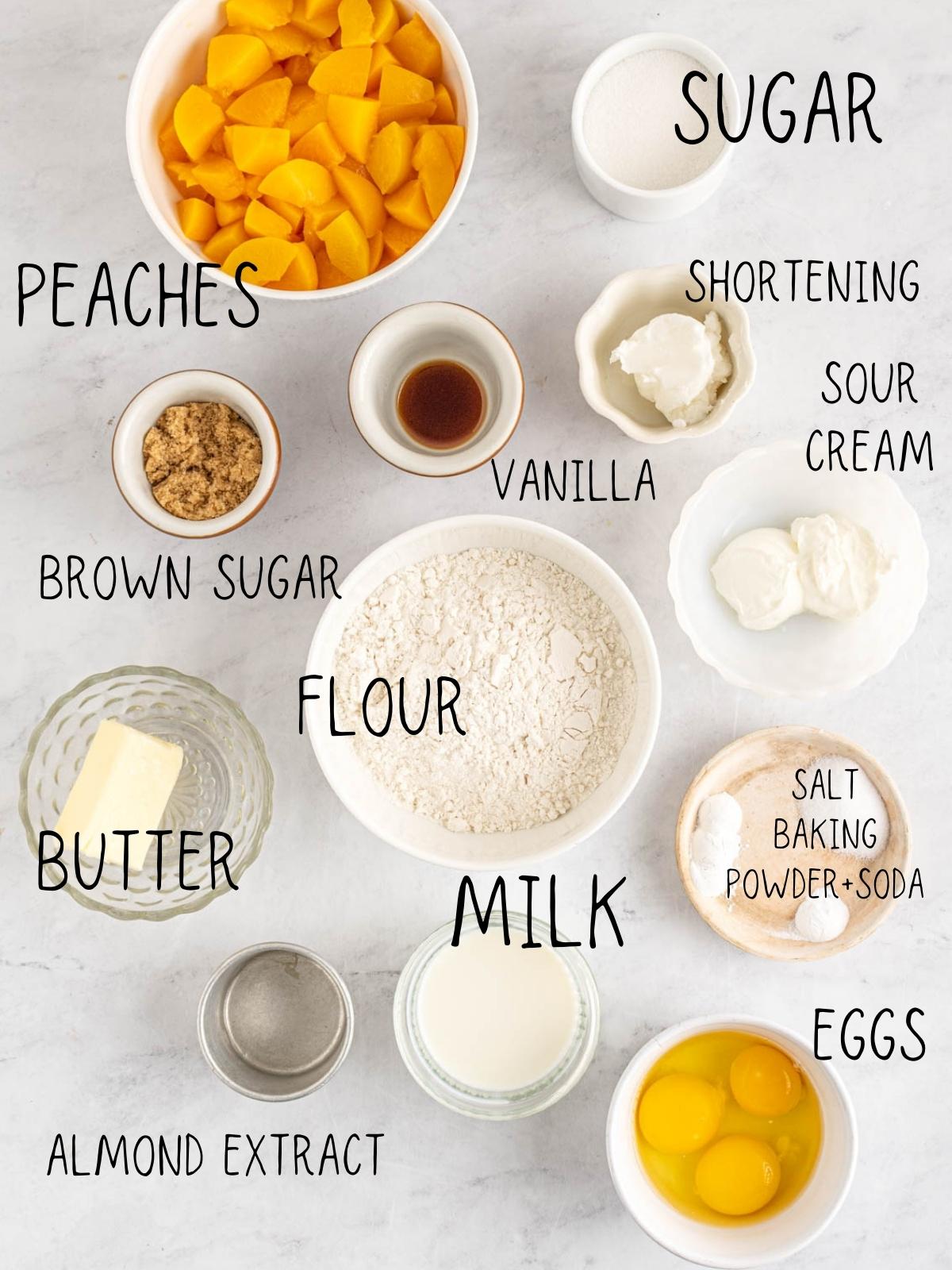 ingredients for peach bread, including milk, salt, eggs, almond extract, butter, flour, Brown sugar, vanilla, sour cream, peaches, and sugar