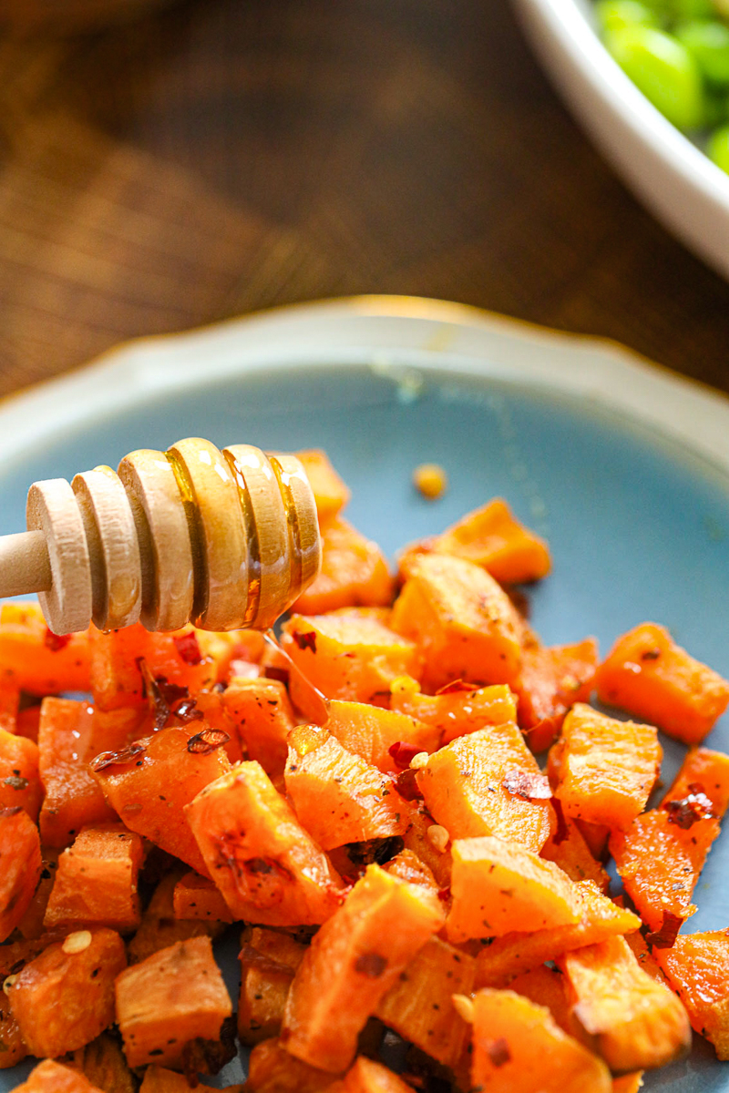 drizzling honey on roasted sweet potato bites