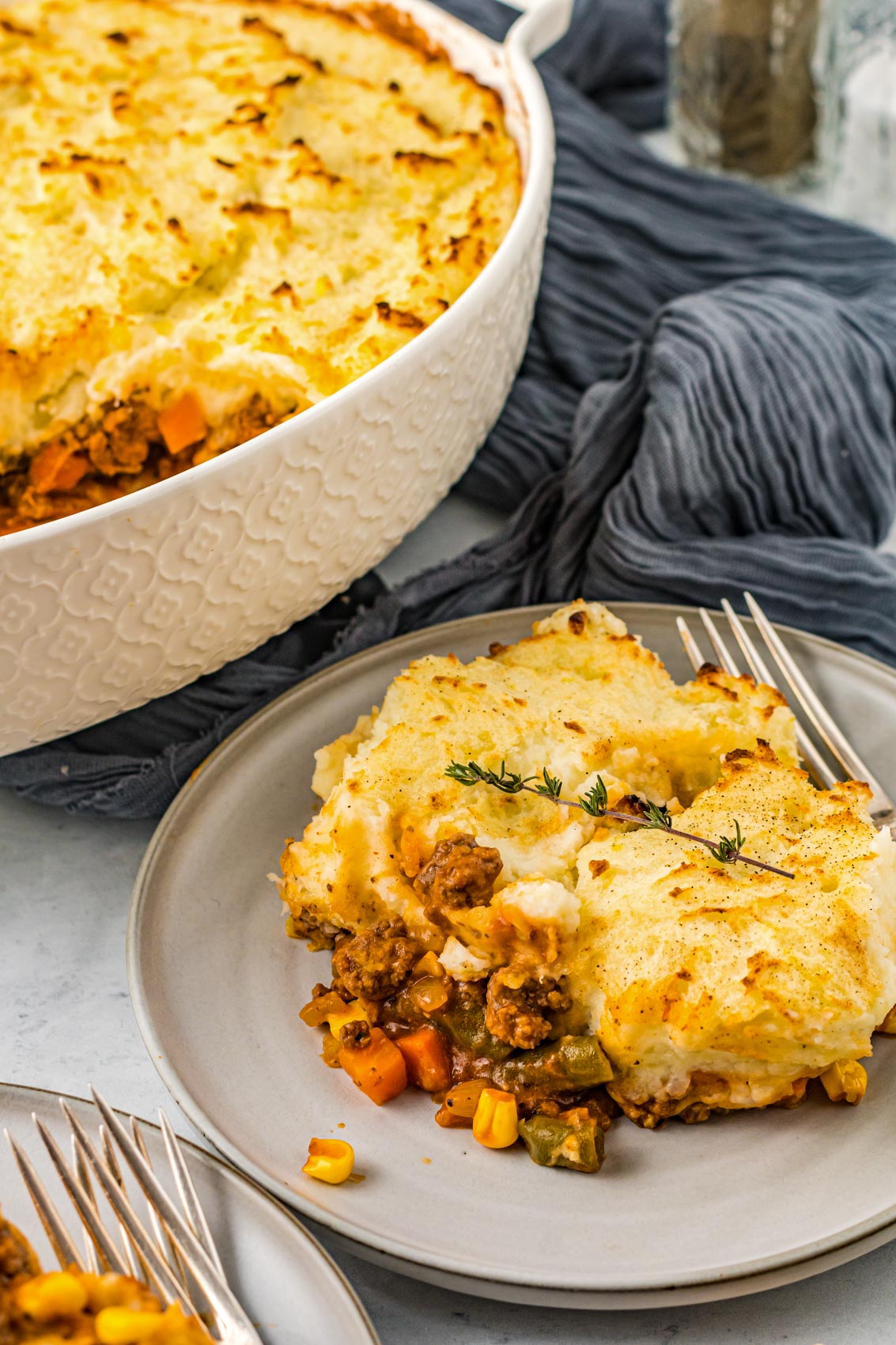 shepherds pie on a plate next to a casserole dish