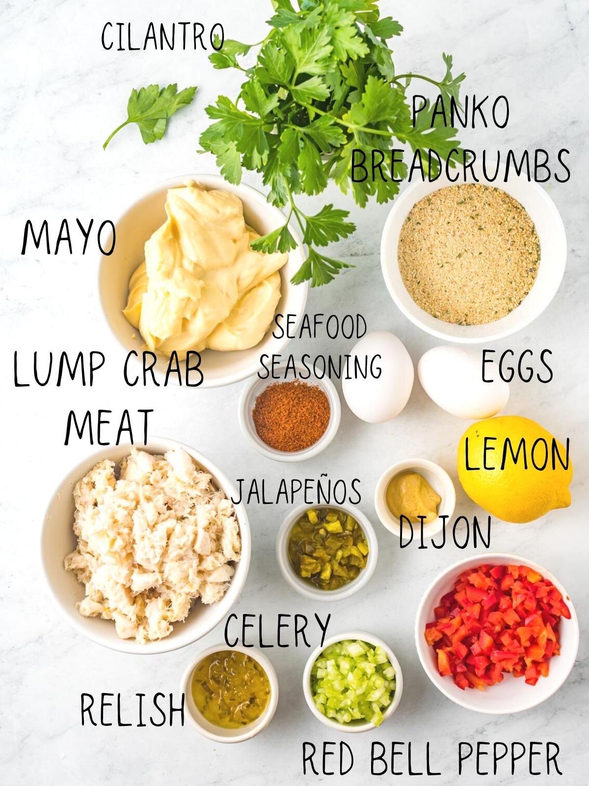 ingredients for air fryer crab cakes including lemon, red bell pepper, dijon, mayo, and lump crab meat