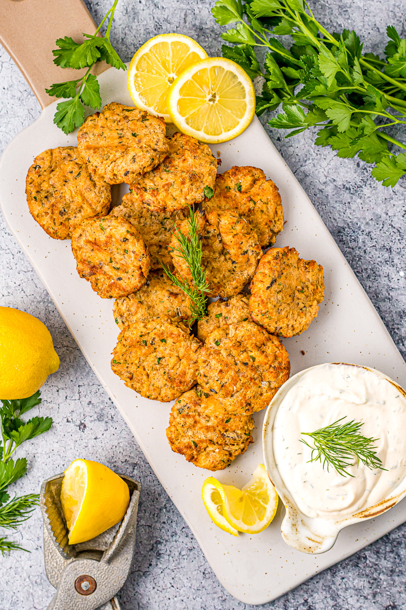 salmon patties next to parsley and lemon