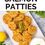 salmon patties on a tray with lemon and dill sauce