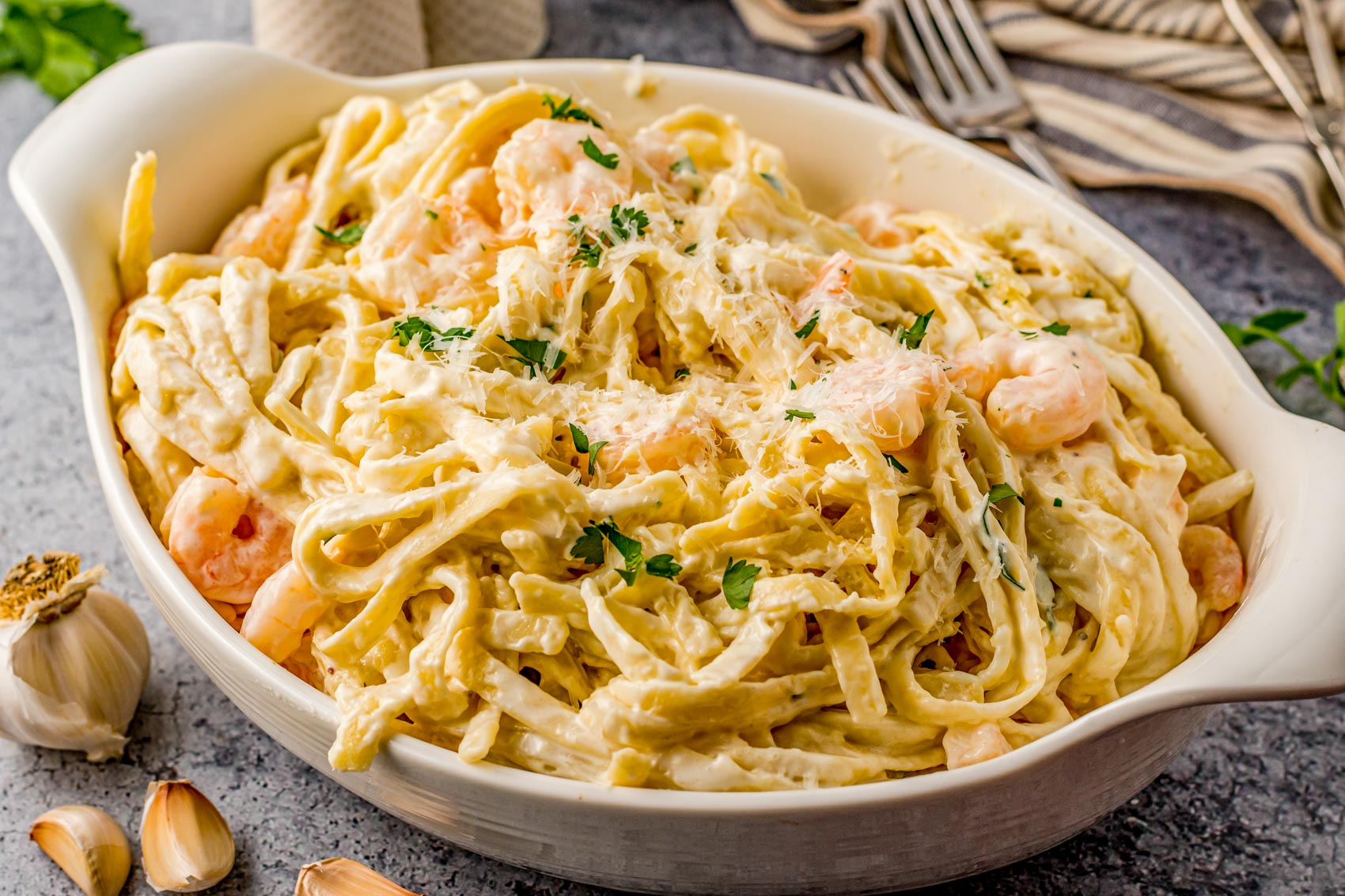 creamy shrimp Alfredo in a white baking dish