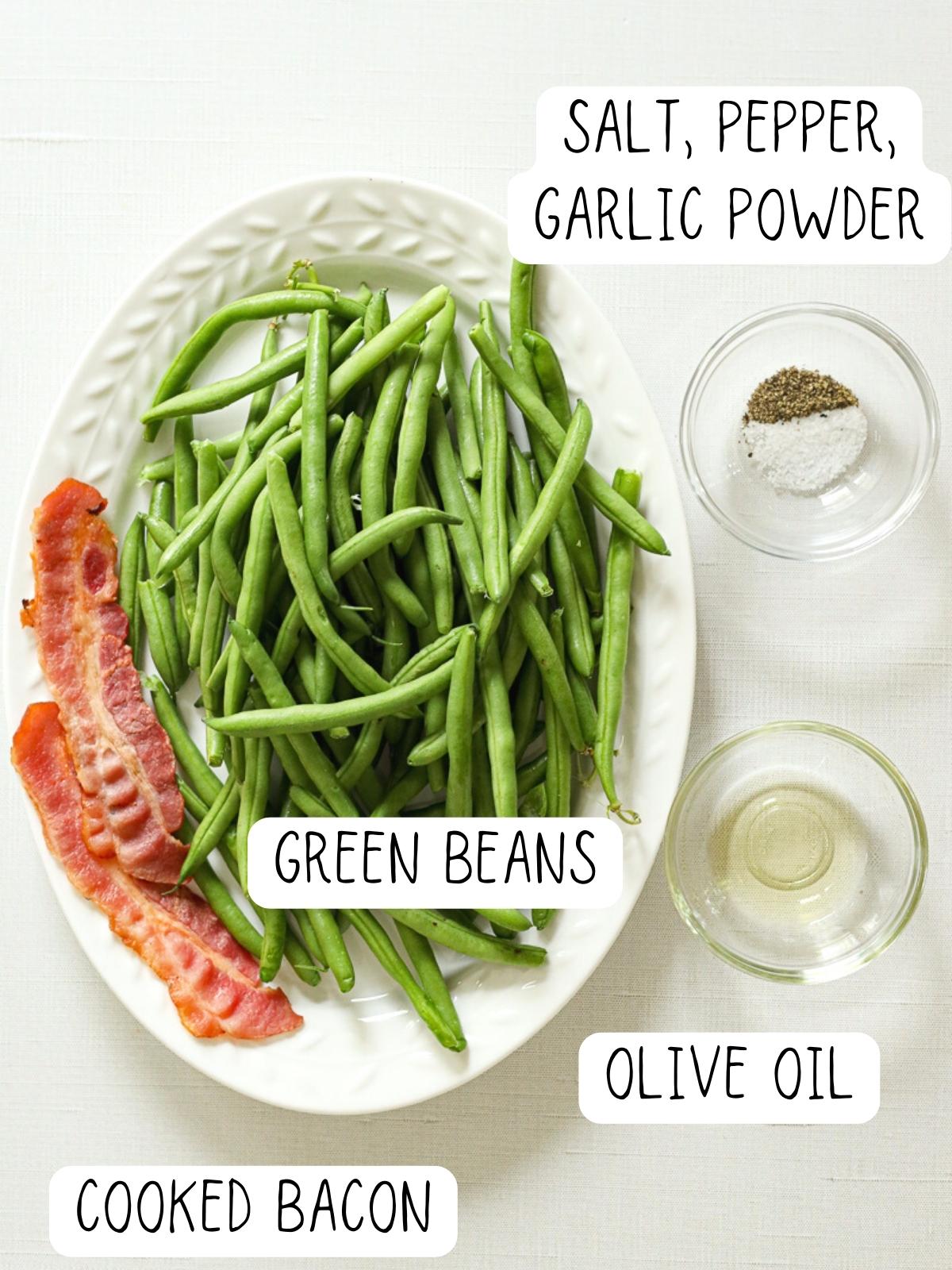 ingredients for air fryer green beans, including salt, pepper, olive oil, garlic powder, bacon, and green beans