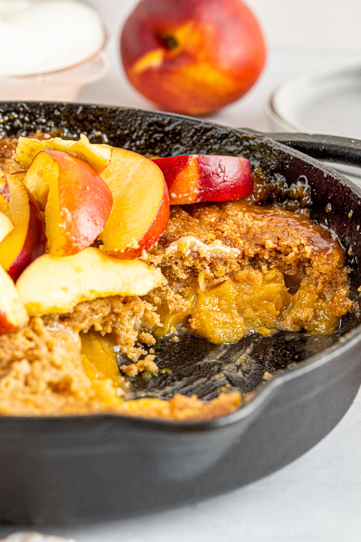 cast iron skillet with peach cobbler