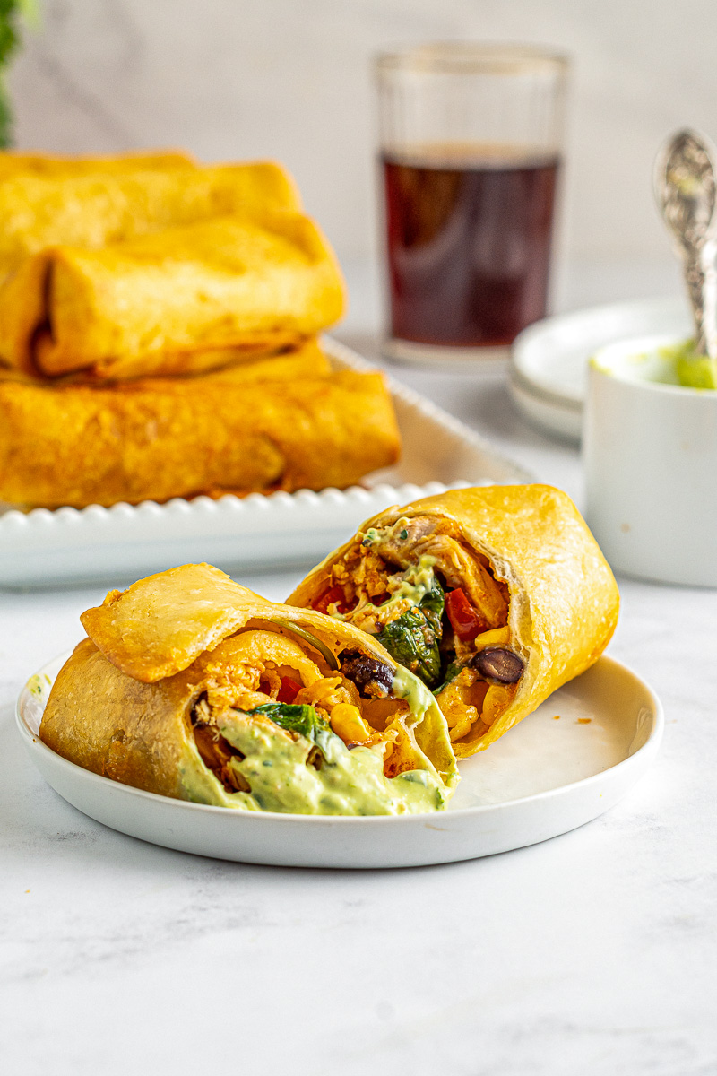 fried southwest egg roll covered in avocado ranch sauce