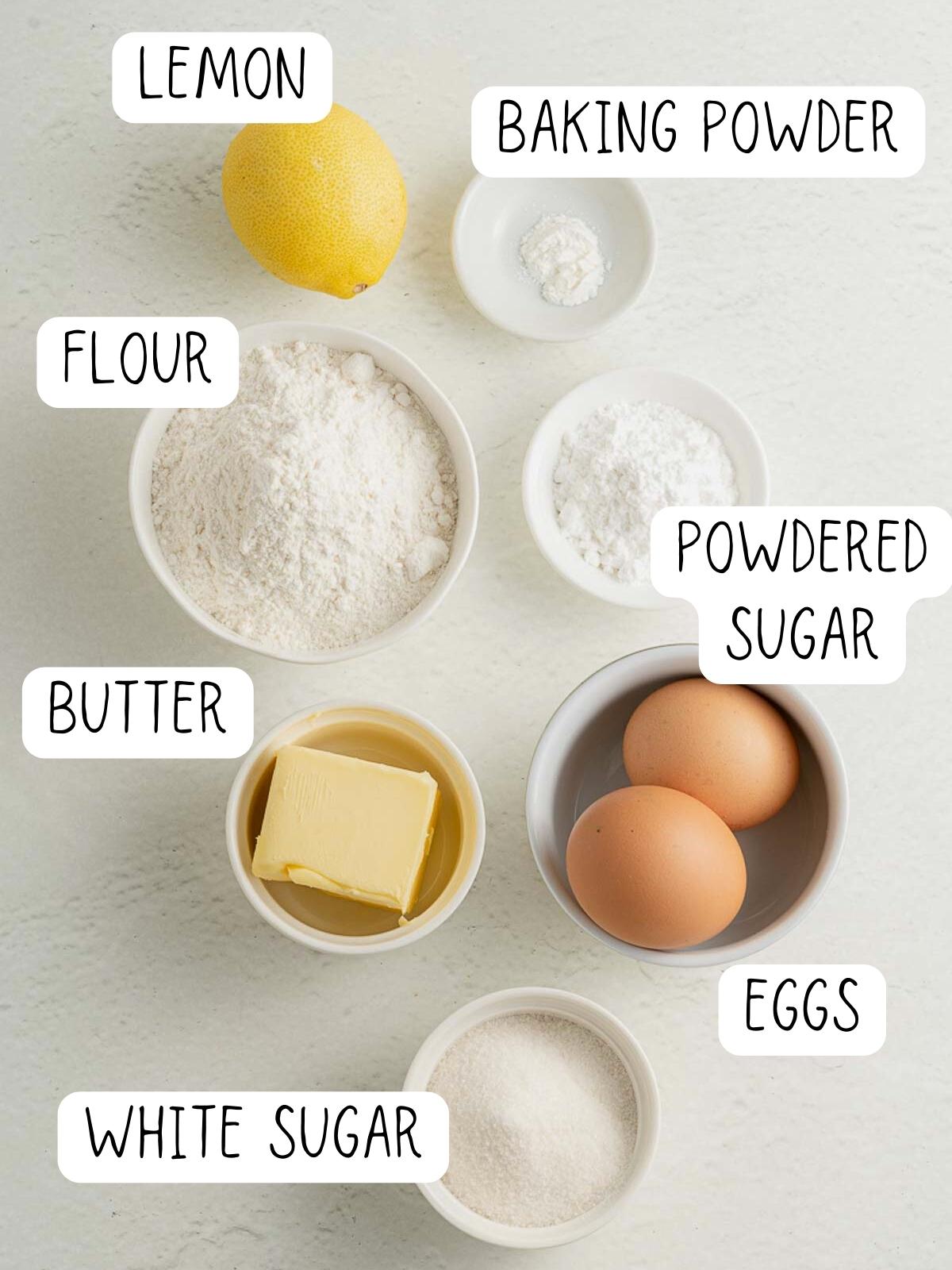ingredients for lemon brownies, including sugar, eggs, lemon, butter, powdered sugar, and flour