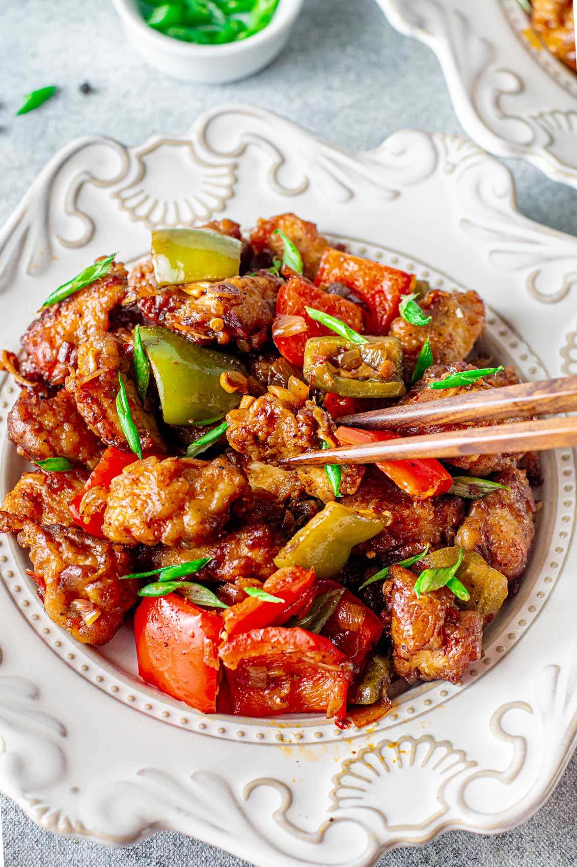 crispy black pepper chicken with bell peppers and green onion
