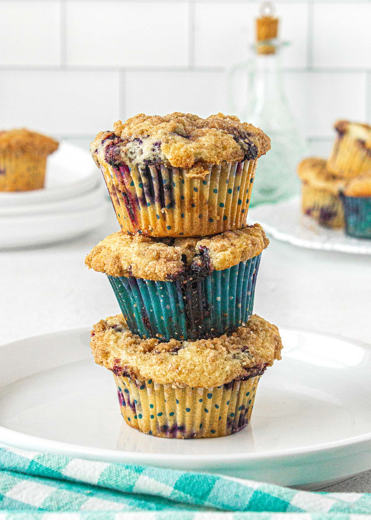 three blueberry muffins stacked on top of one another