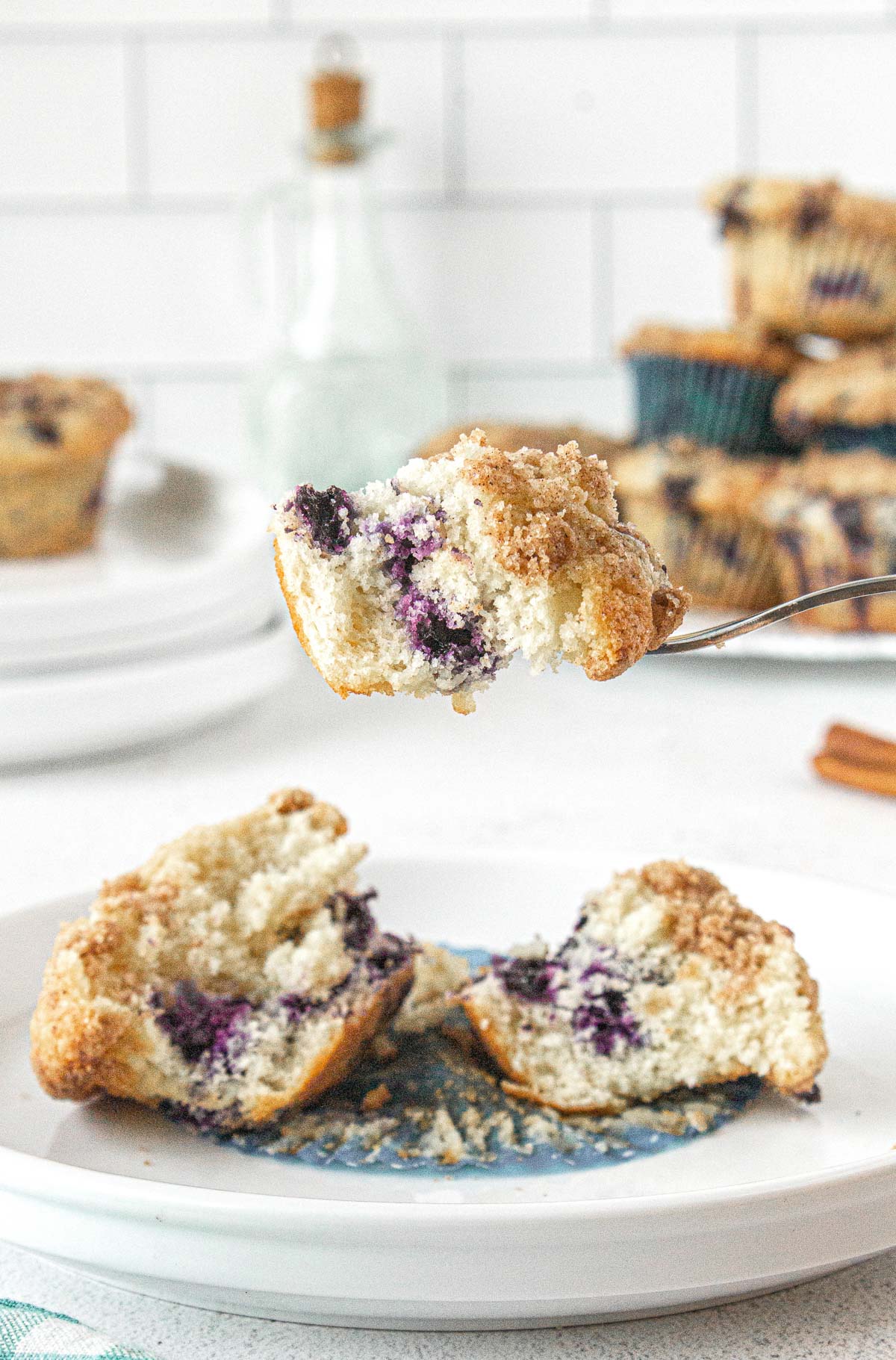 fork lifting up a bite of soft blueberry muffin