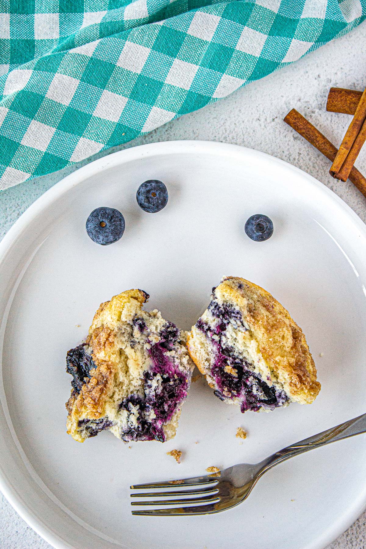 blueberry muffin broken open revealing fresh gooey blueberries inside