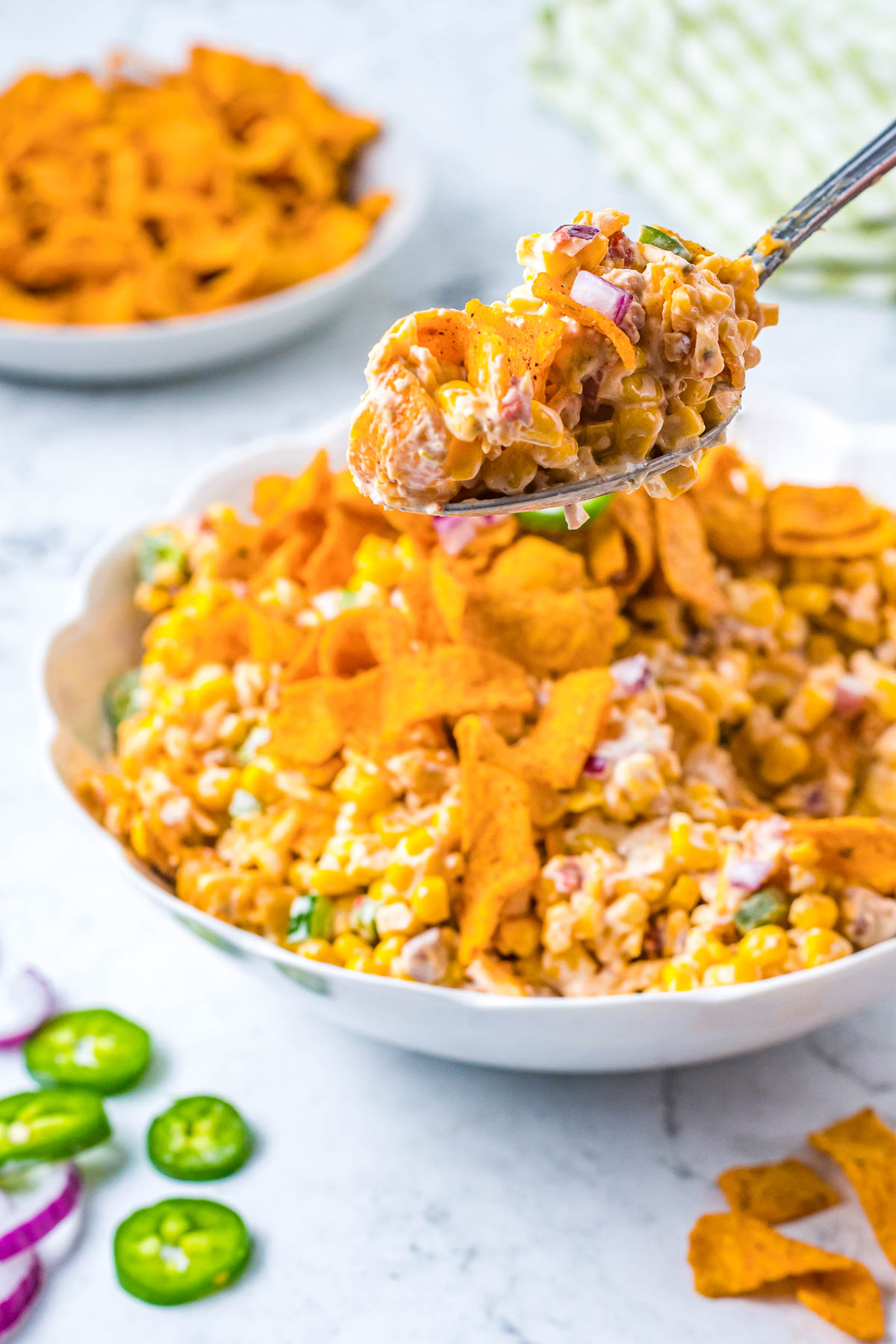 large spoonful of corn chips with corn salad