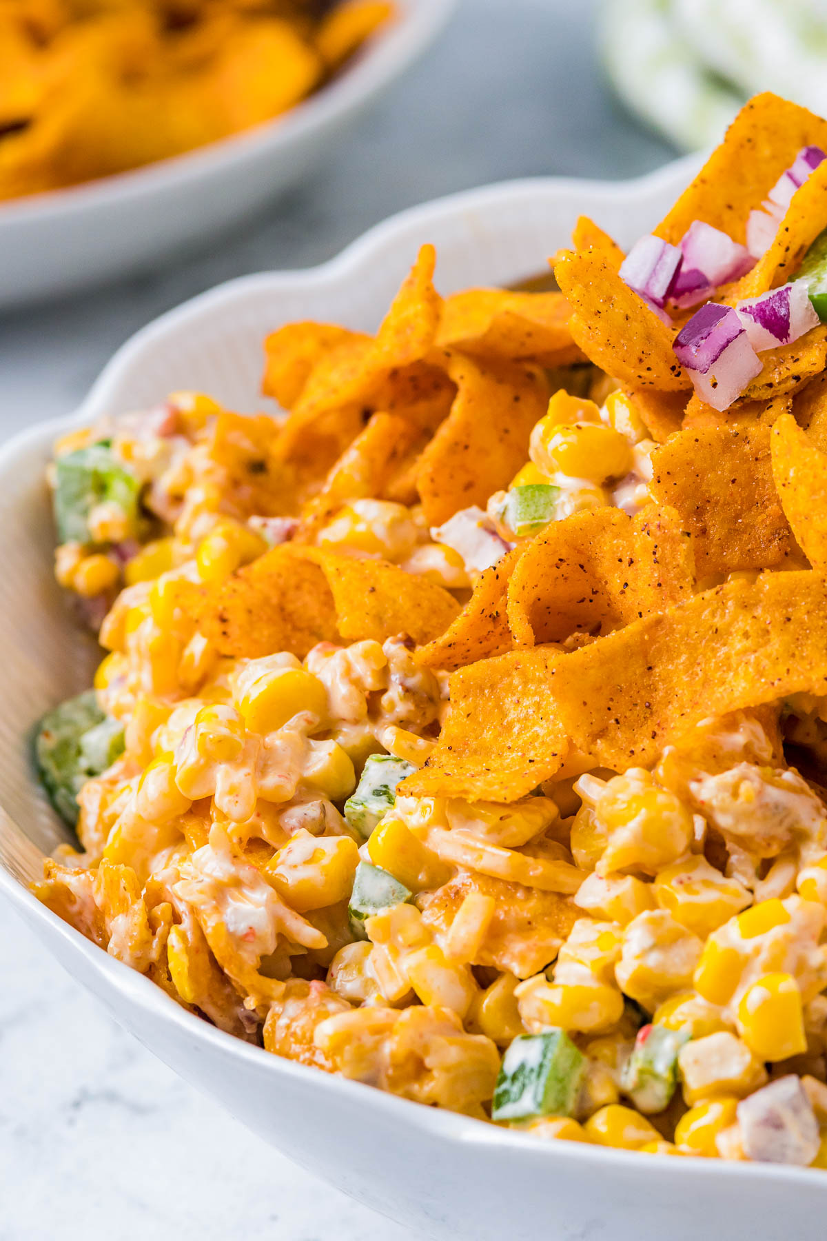 side view of a large bowl filled with Frito corn salad dip