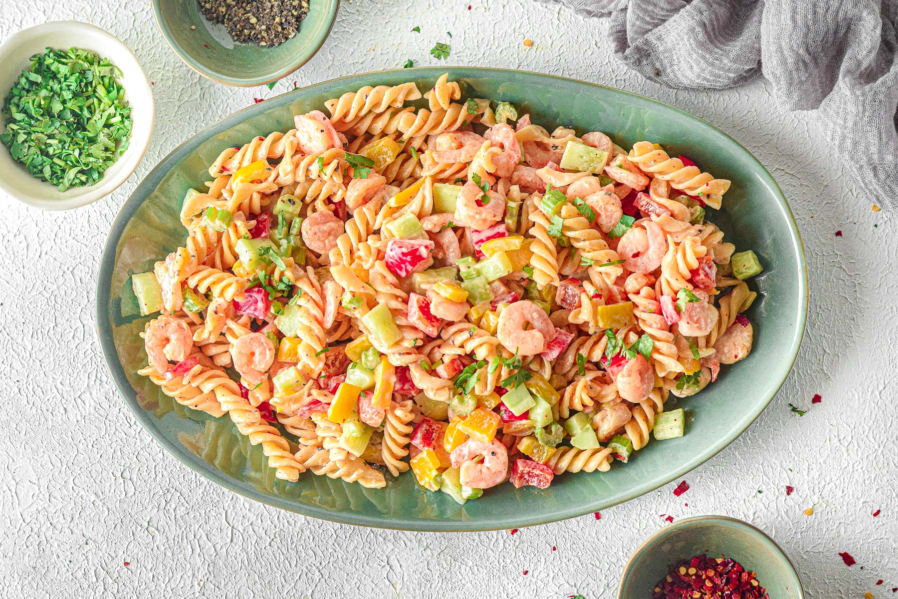 platter with creamy shrimp pasta salad next to parsley