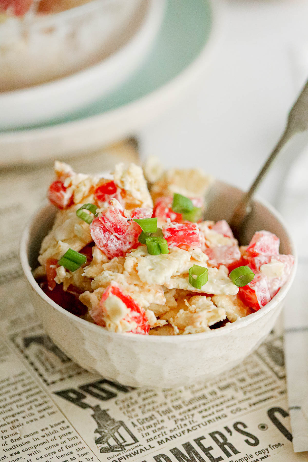 tomato cracker salad with mayo and green onions as garnish