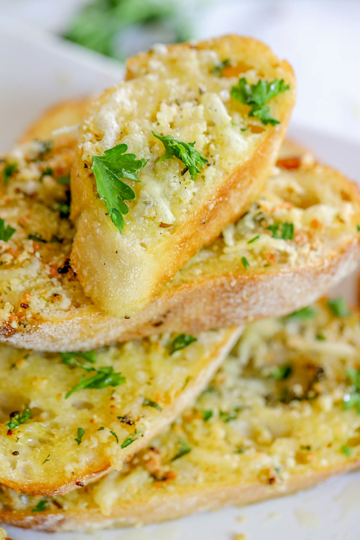 stack of garlic bread slices with parsley as a garnish